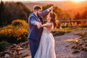 Bride and groom smiling and laughing at sunset