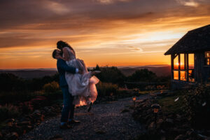 bride and groom kiss at sunset