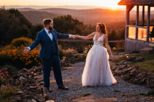 bride and groom on path at sunset