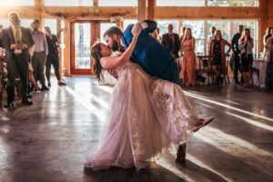 Groom dipping bride during first dance