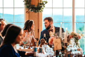 bride and groom looking at each other during toast