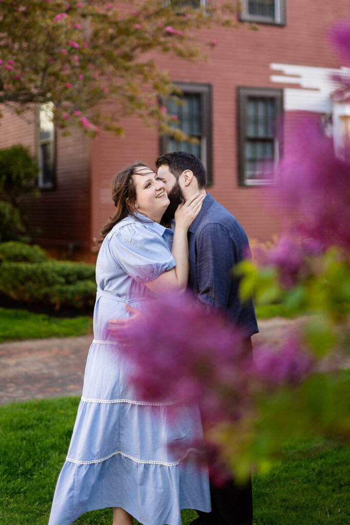 Man kissing the neck of his bride to be in spring Portsmouth NH Engagement Photos by Lisa Smith Photography  