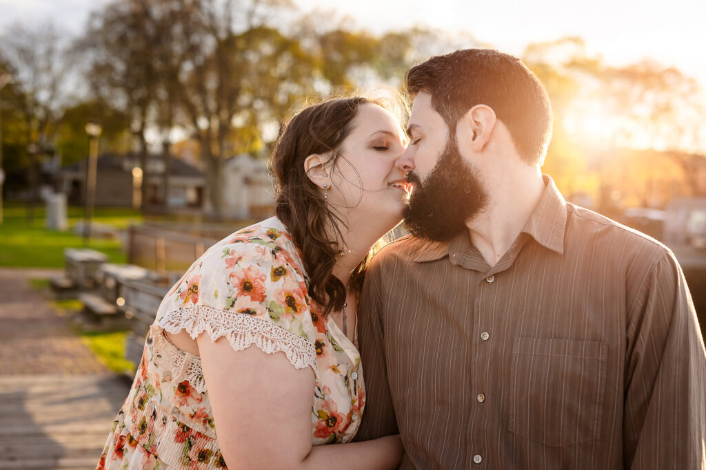 An intimate kiss between engaged couple at Prescott Part sunset in Portsmouth NH Engagement Photos by Lisa Smith Photography