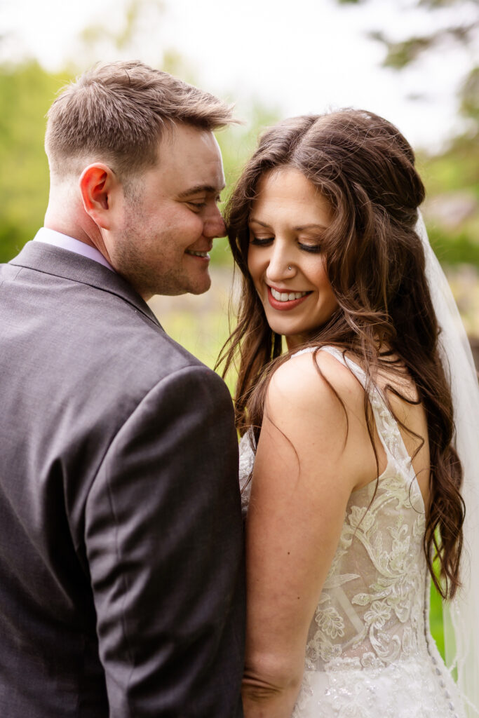 Groom snuggling with bride in portrait at Birchwood Vineyard  by Lisa Smith Photography