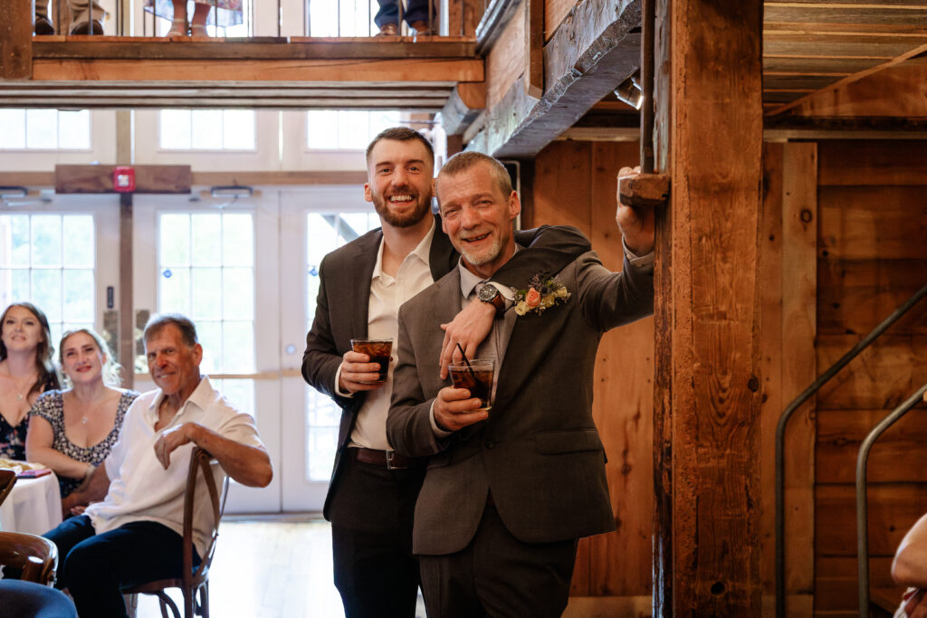 Candid moment between father and son during wedding reception at Josiah's Meetinghouse wedding by Lisa Smith Photography