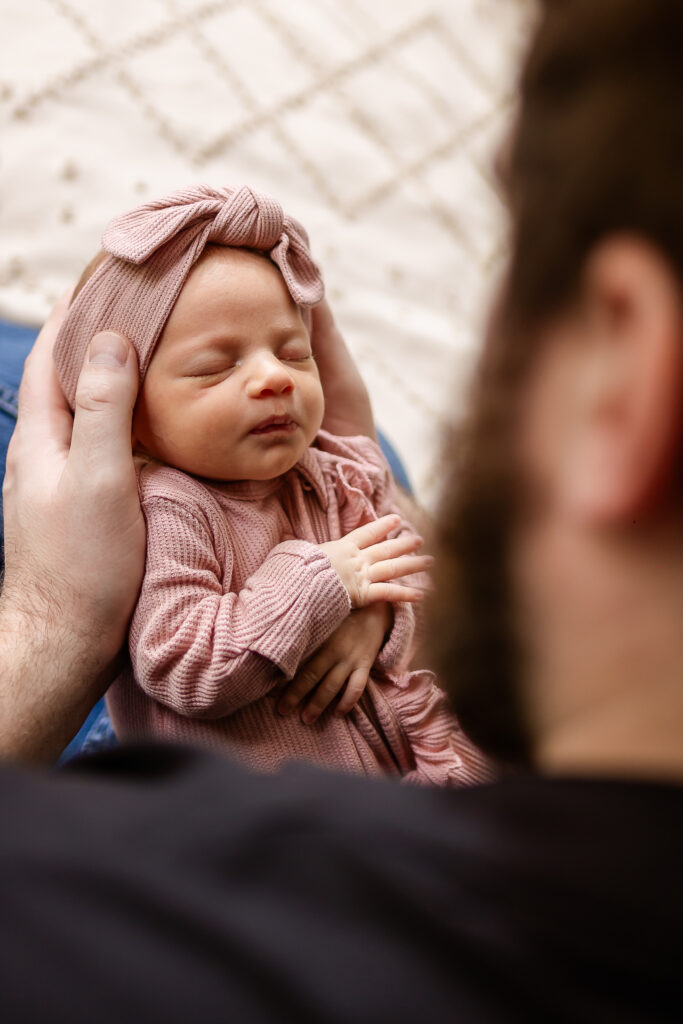 dad holding baby girl during in home newborn photo session by NH Newborn Photographer Lisa Smith Photographer