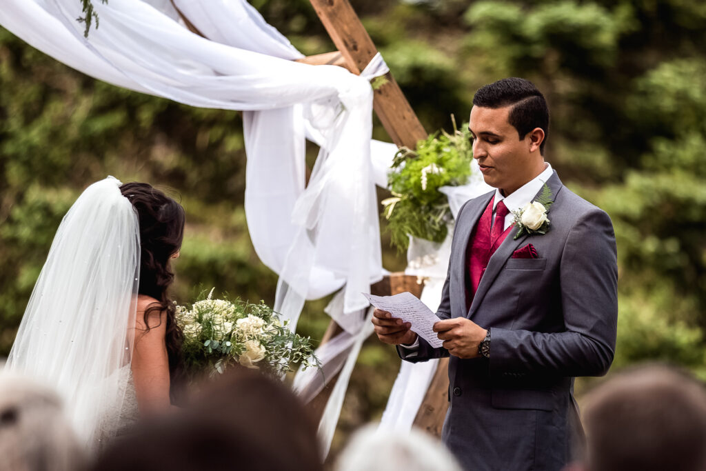 Groom reading vows to bride during wedding ceremony by nh wedding photographer Lisa Smith Photography