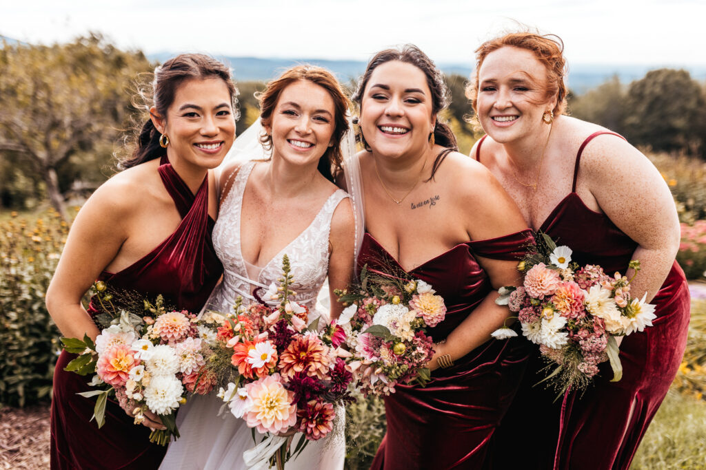 Bride and bridesmaids smiling and laughing at with beautiful wedding makeup