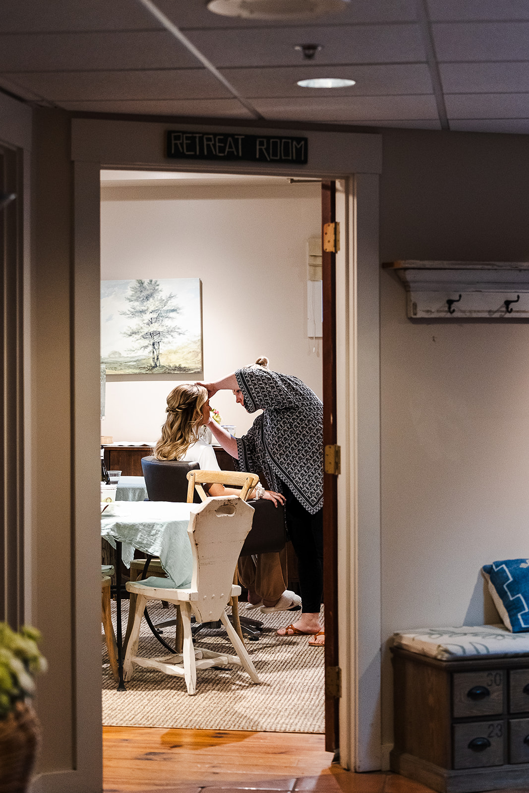 candid image of bride getting her makeup before wedding at the Barn on the Pemi in Plymouth NH

